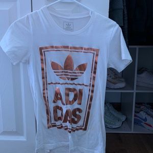 white t shirt with gold adidas logo